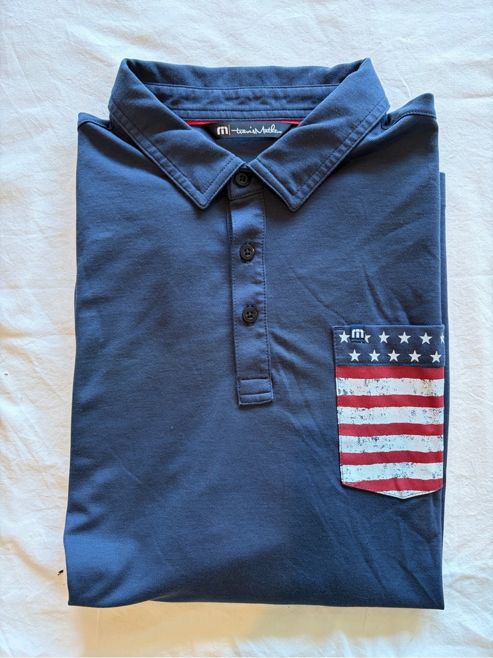 Travis Mathew Men's Navy Polo with American Flag Pocket